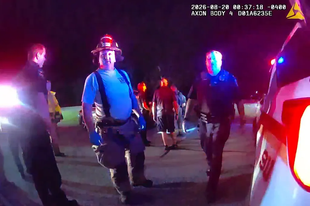 Police body cam footage shows first responders working at a crime scene at night.