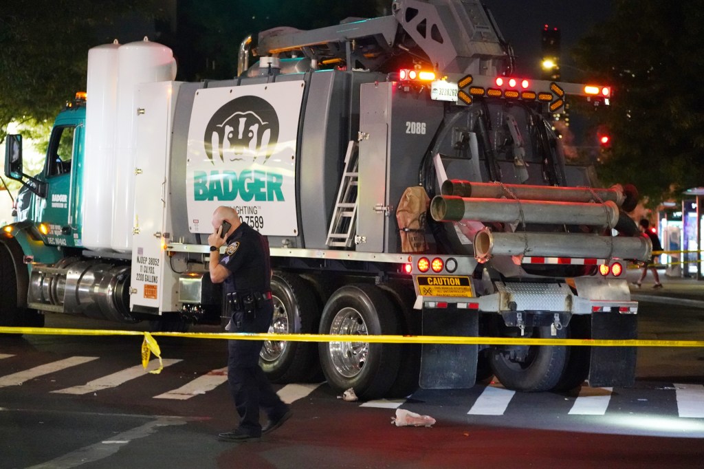 Police gather at the scene where a bicyclist was critically injured after being struck by a truck.