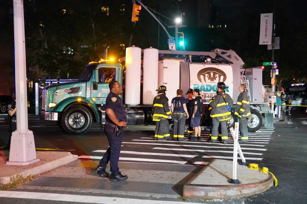 Police and FDNY first responders at the scene where a bicyclist was critically injured after being struck by a truck on First Avenue at E14th Street in New York.
