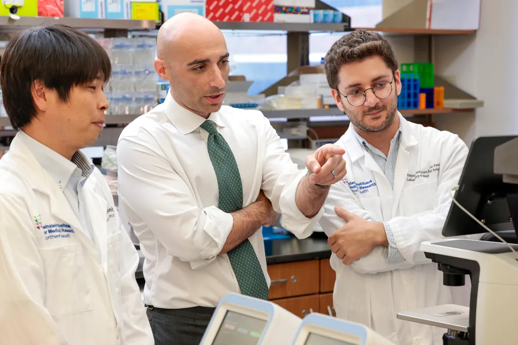 Dr. Kenji Mikki, Dr. Kalil Abdullah, and Dr. Maged Ghoche collaborating in a lab.