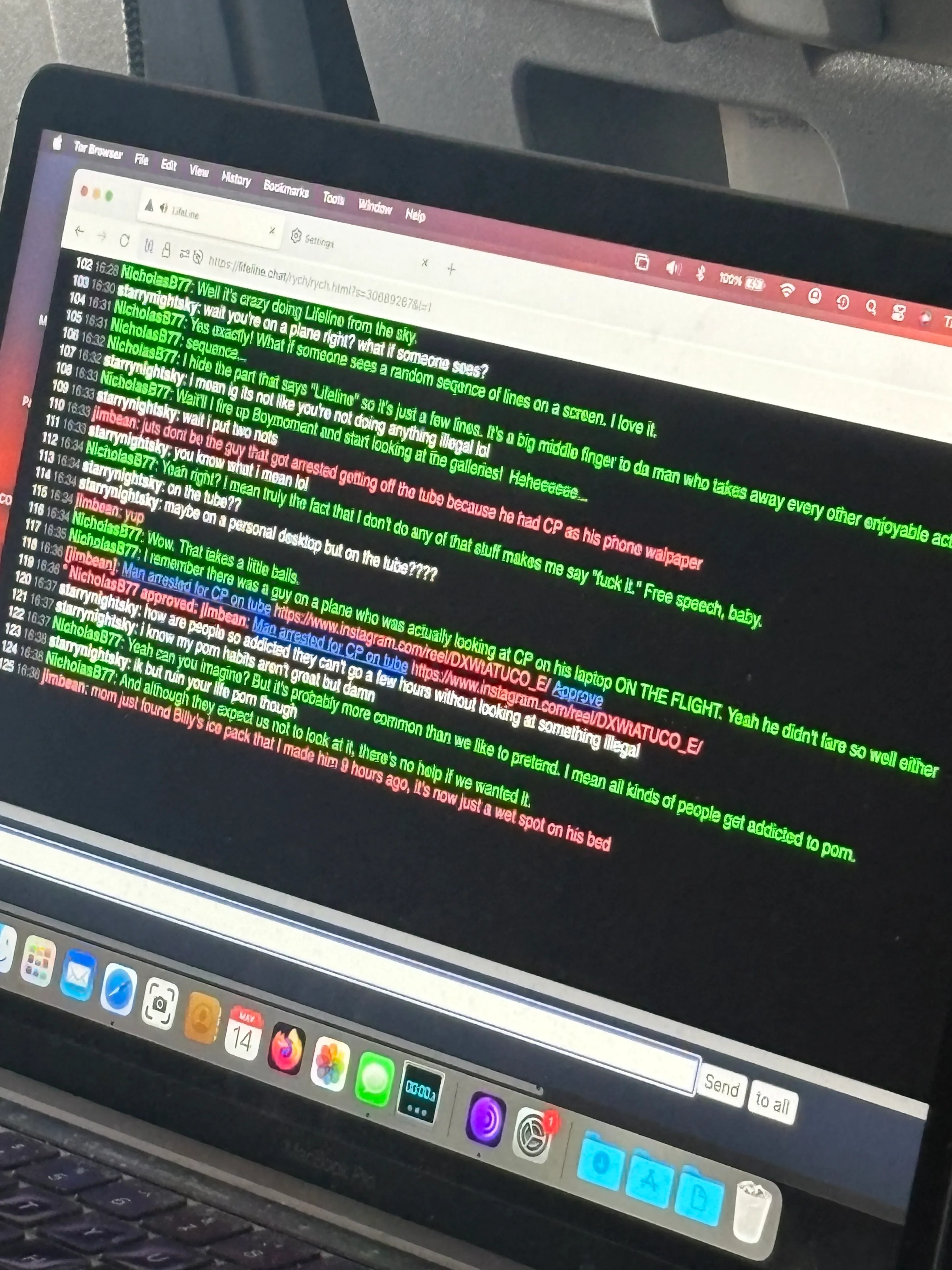 A photograph of a laptop screen displaying a chatroom conversation on