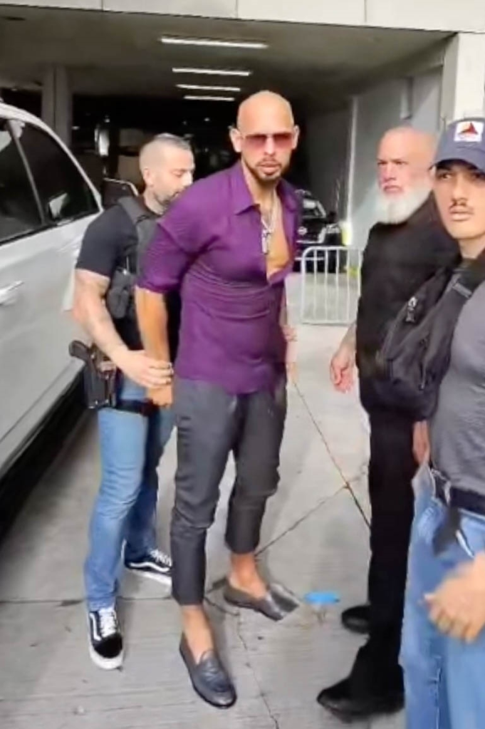 Andrew Tate being escorted by U.S. Marshals outside the IBA Bare Knuckle Fights event in Miami.