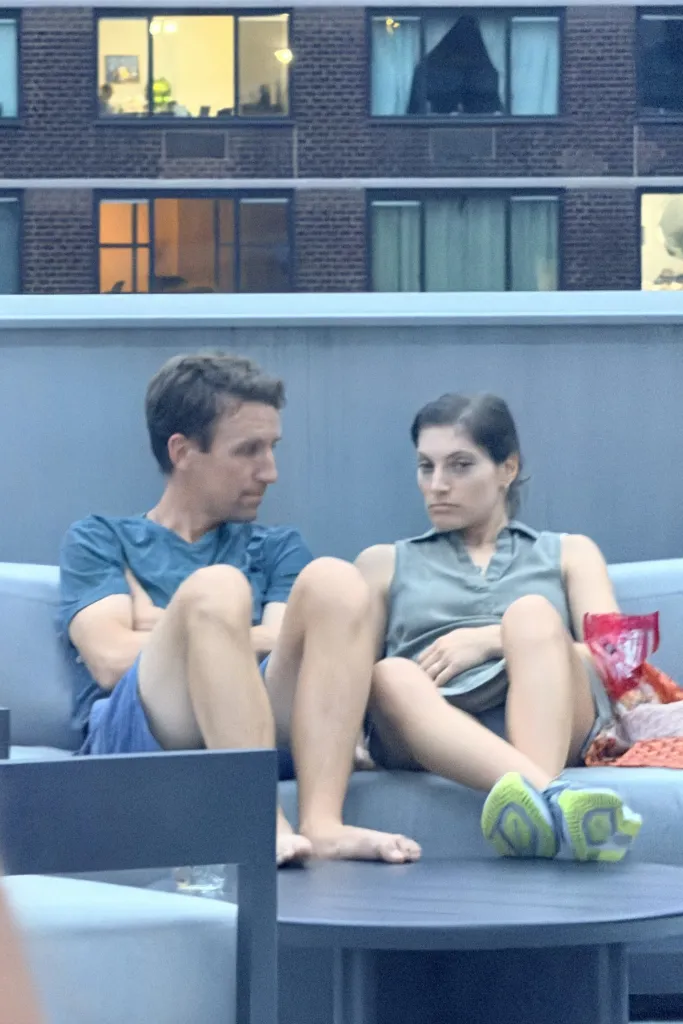 Patrick Clancy and Rachel Danis sitting on a couch on a patio.