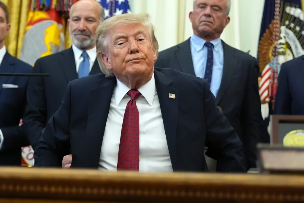 President Donald Trump seated at a desk in the Oval Office.