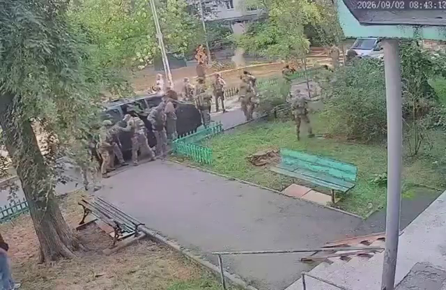 Investigators at a cordoned-off scene following a shootout in Kyiv.