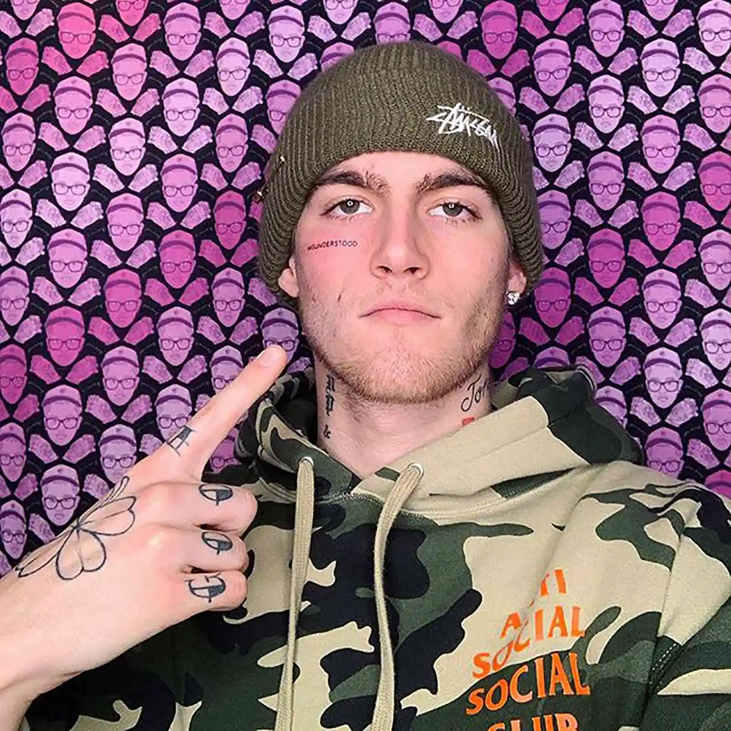 Presley Gerber in a promotional image, wearing a beanie and camouflage hoodie, with his 