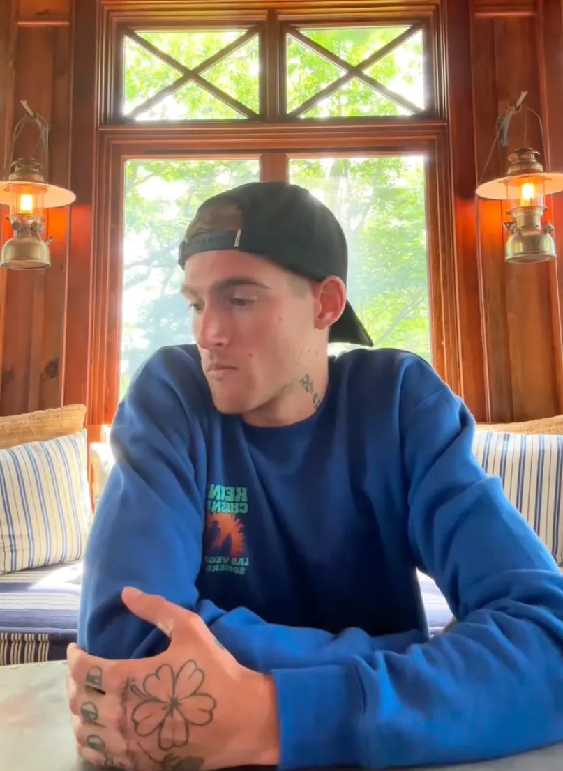 Presley Gerber, model son of Cindy Crawford and Rande Gerber, in a blue sweatshirt with a black baseball cap worn backward.