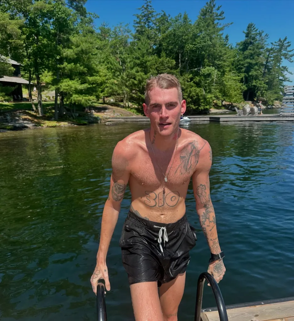 Presley Gerber climbing out of the water onto a dock.