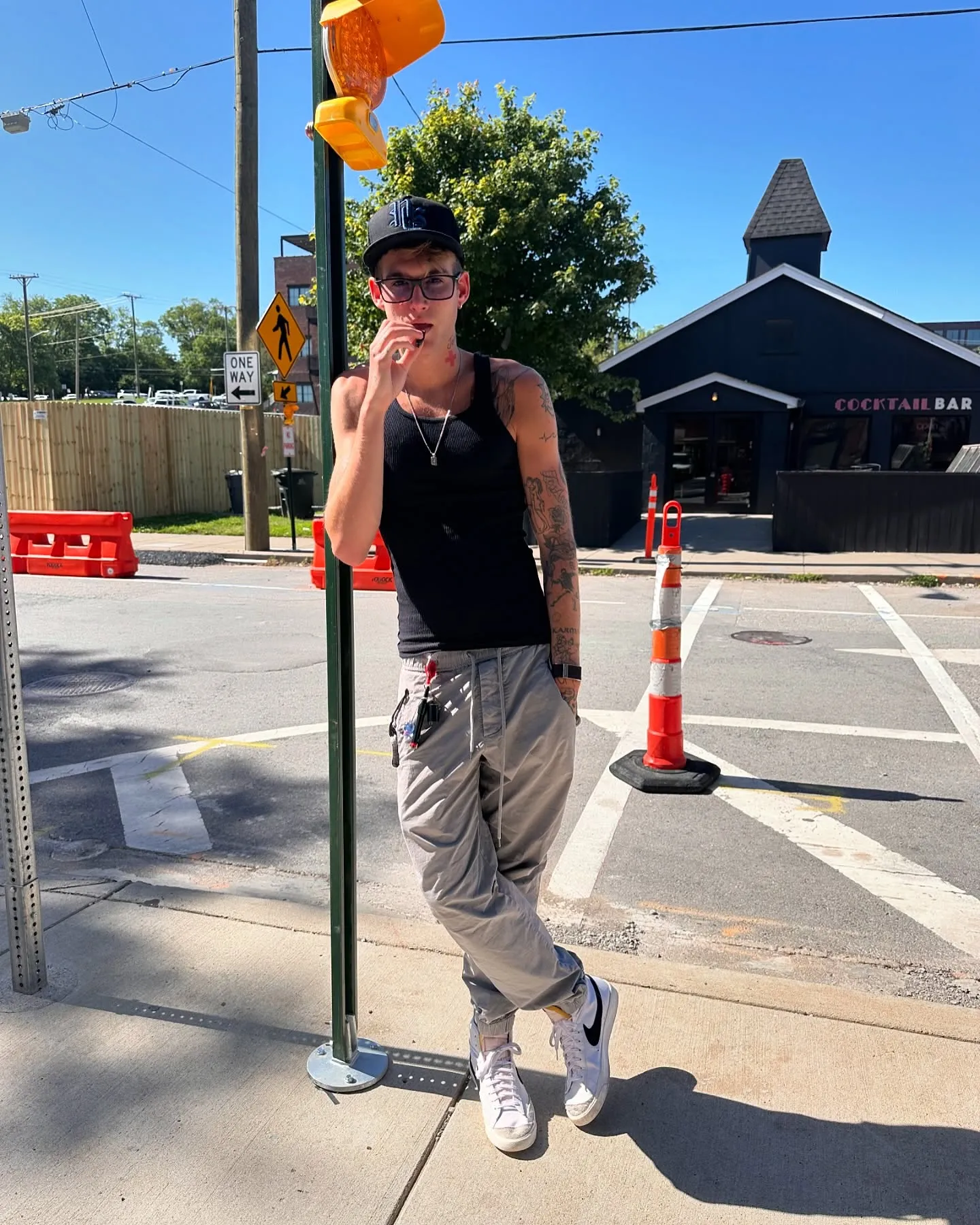 Presley Gerber, model son of Cindy Crawford and Rande Gerber, leans against a pole on a sunny day.