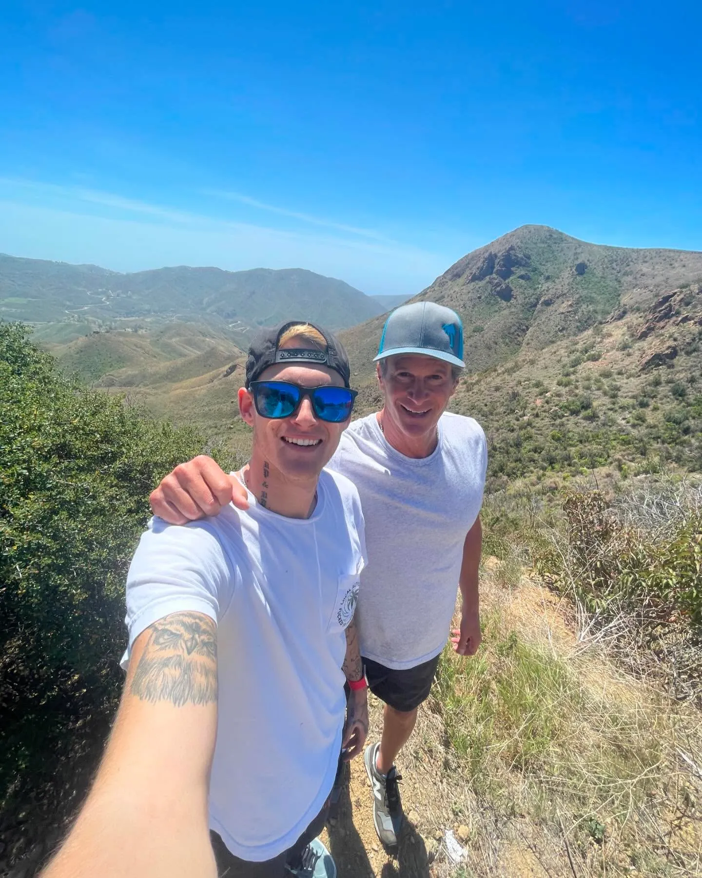 Presley Gerber and Rande posing on a mountain trail.