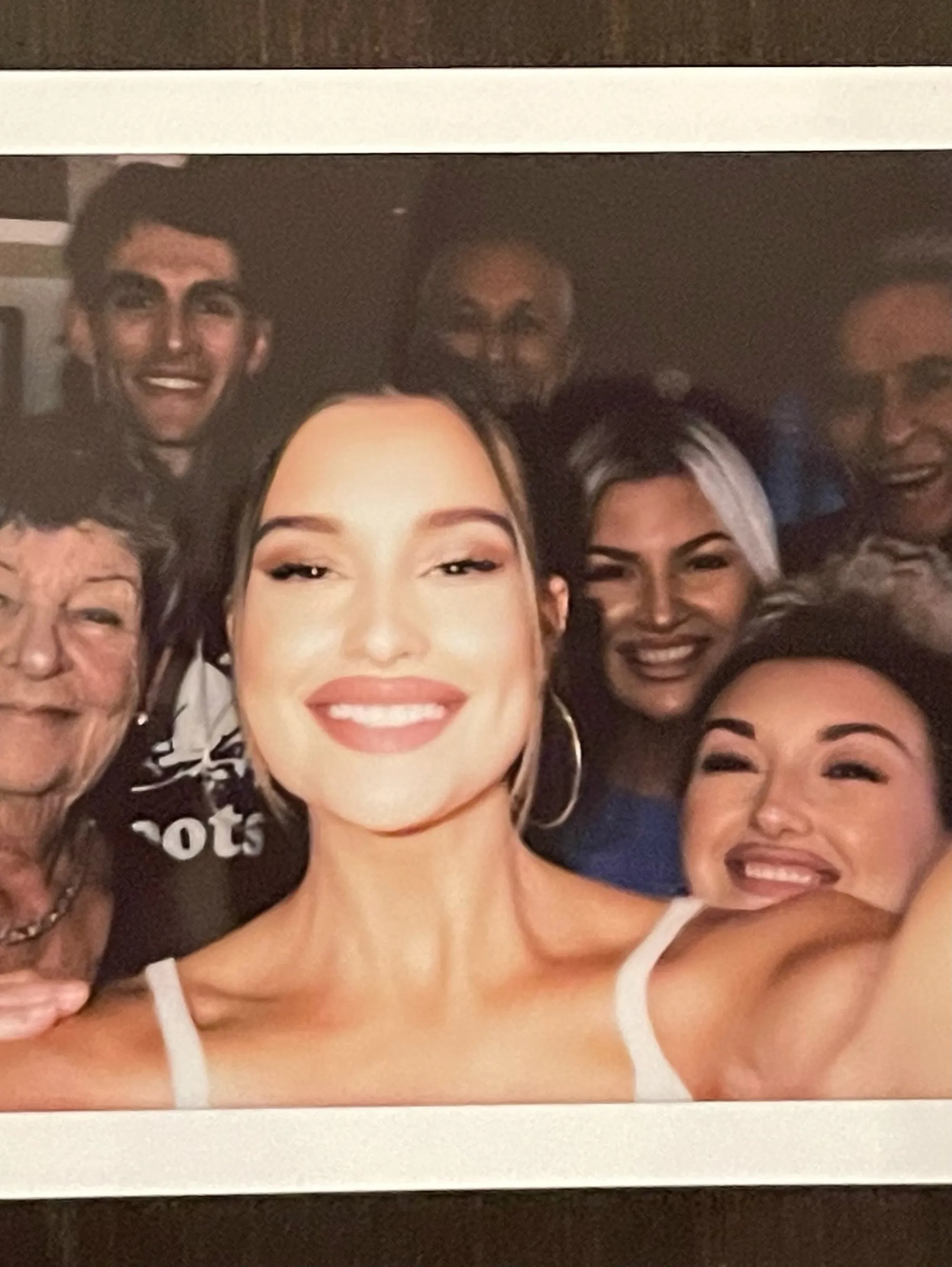 Lexi Wood smiling in a group photo.