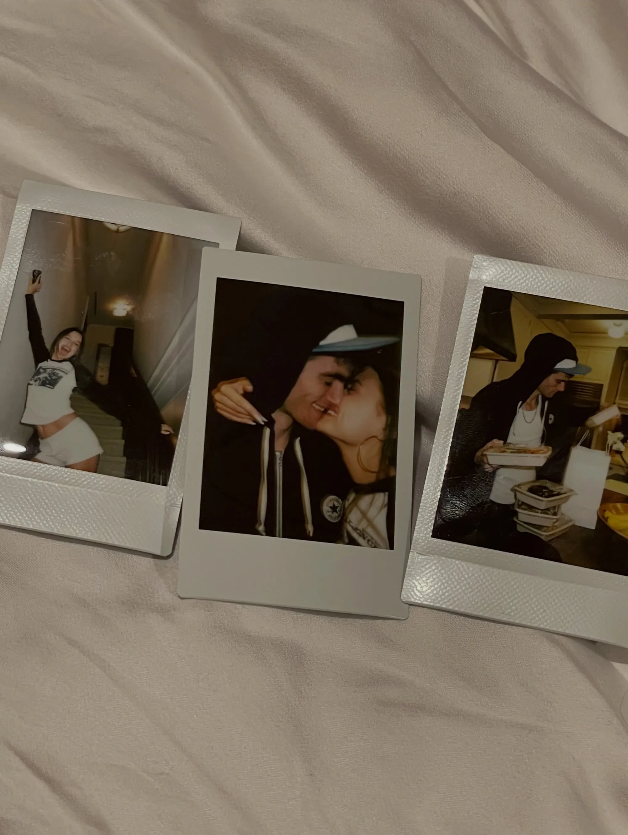 Collage of three polaroid photos showing a couple, with one photo featuring Lexi Wood and Presley Gerber kissing.
