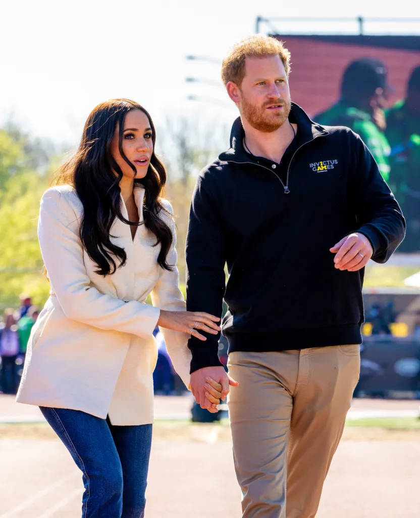 Meghan Markle and Prince Harry holding hands.