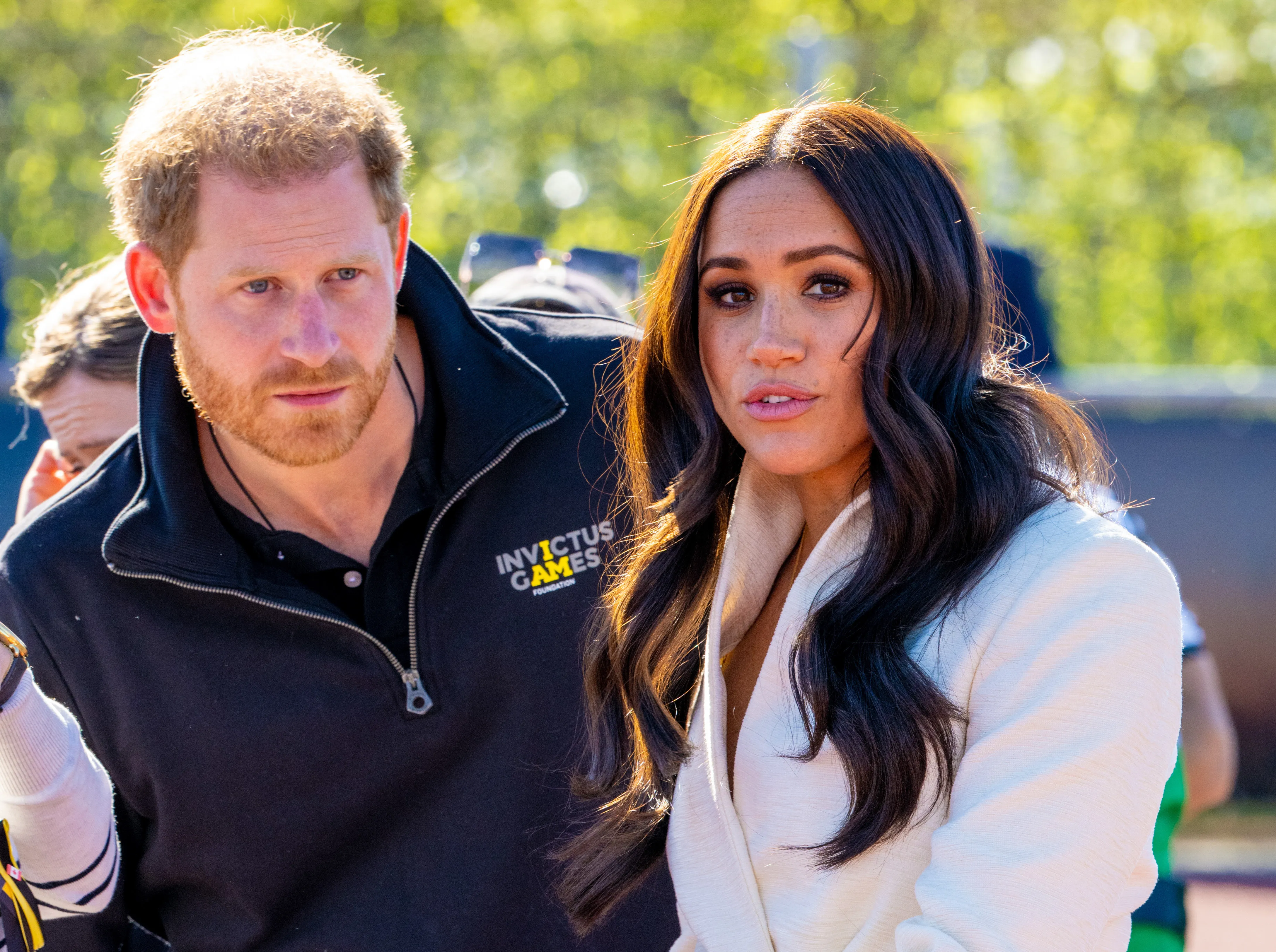 Prince Harry and Meghan Markle standing together outdoors.