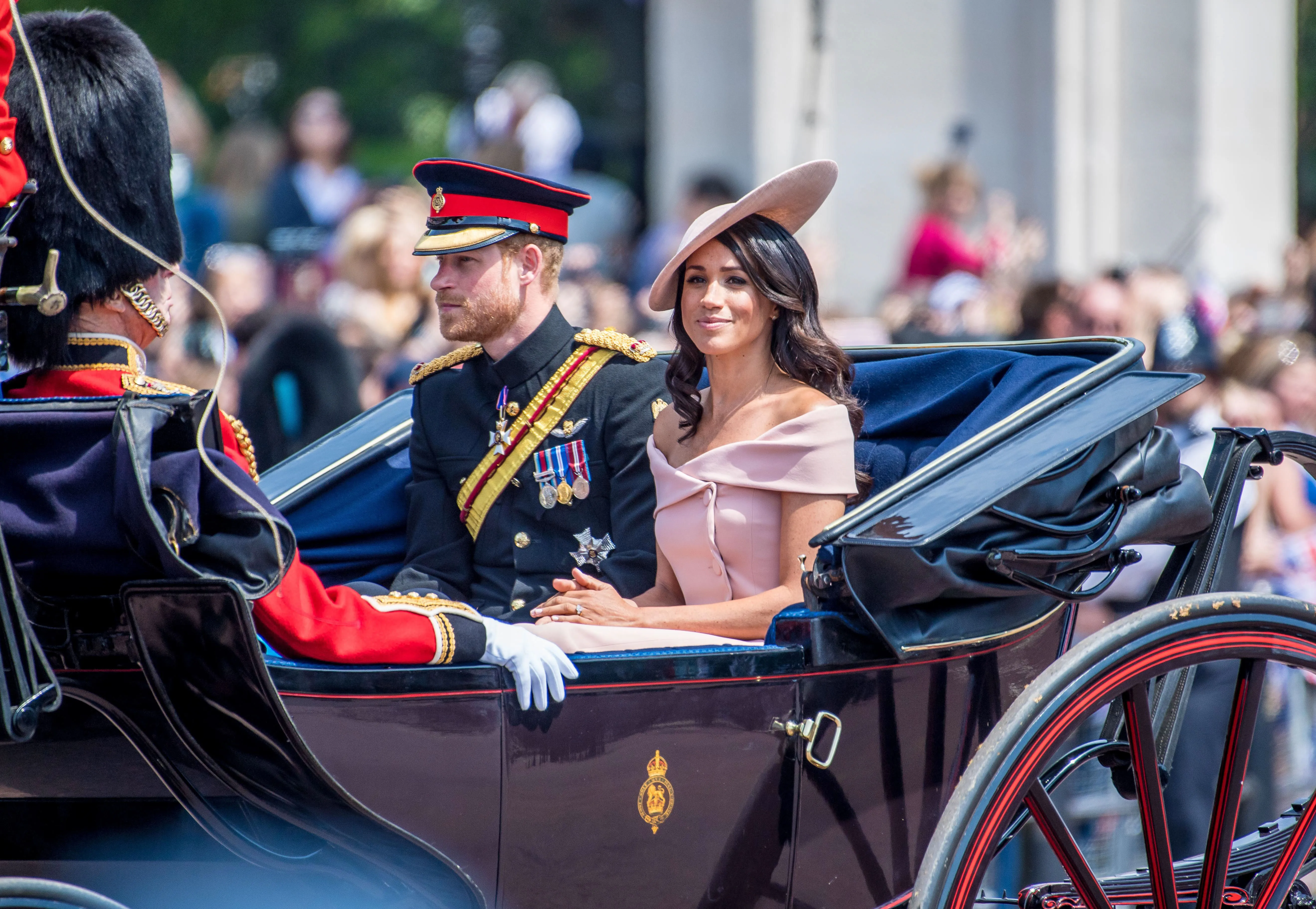 Prince Harry and Meghan Markle riding in a carriage.