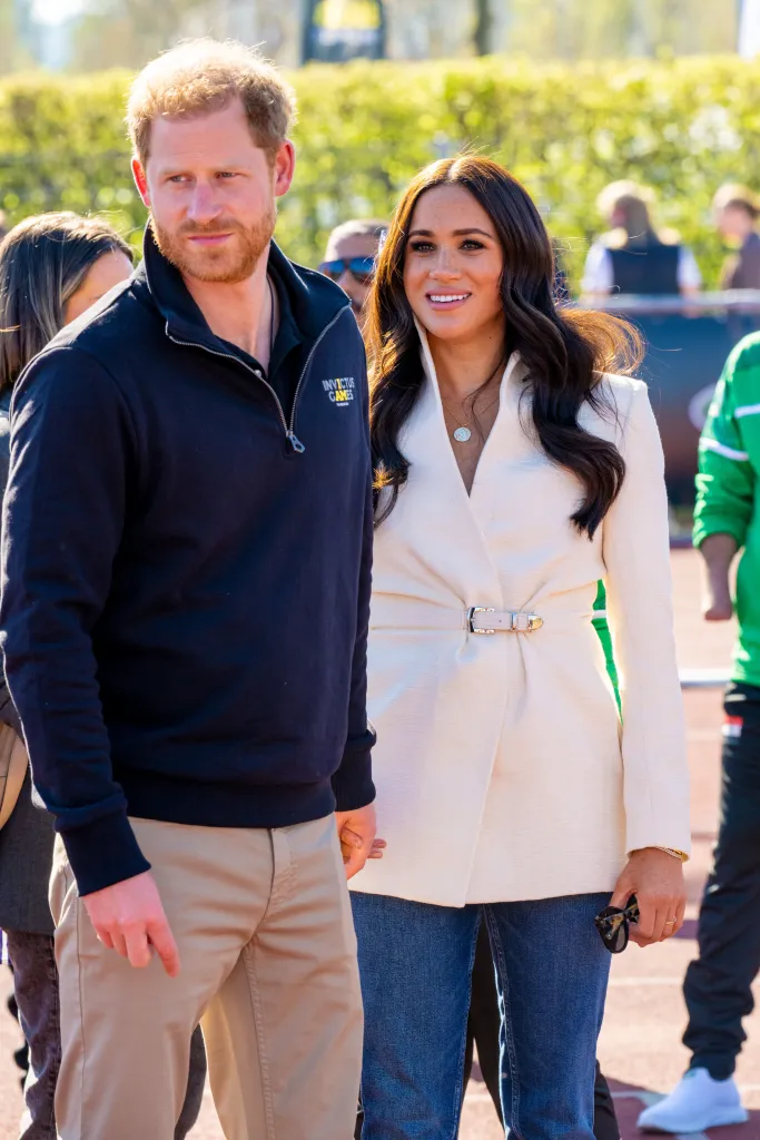 Prince Harry and Meghan Markle standing together outdoors.