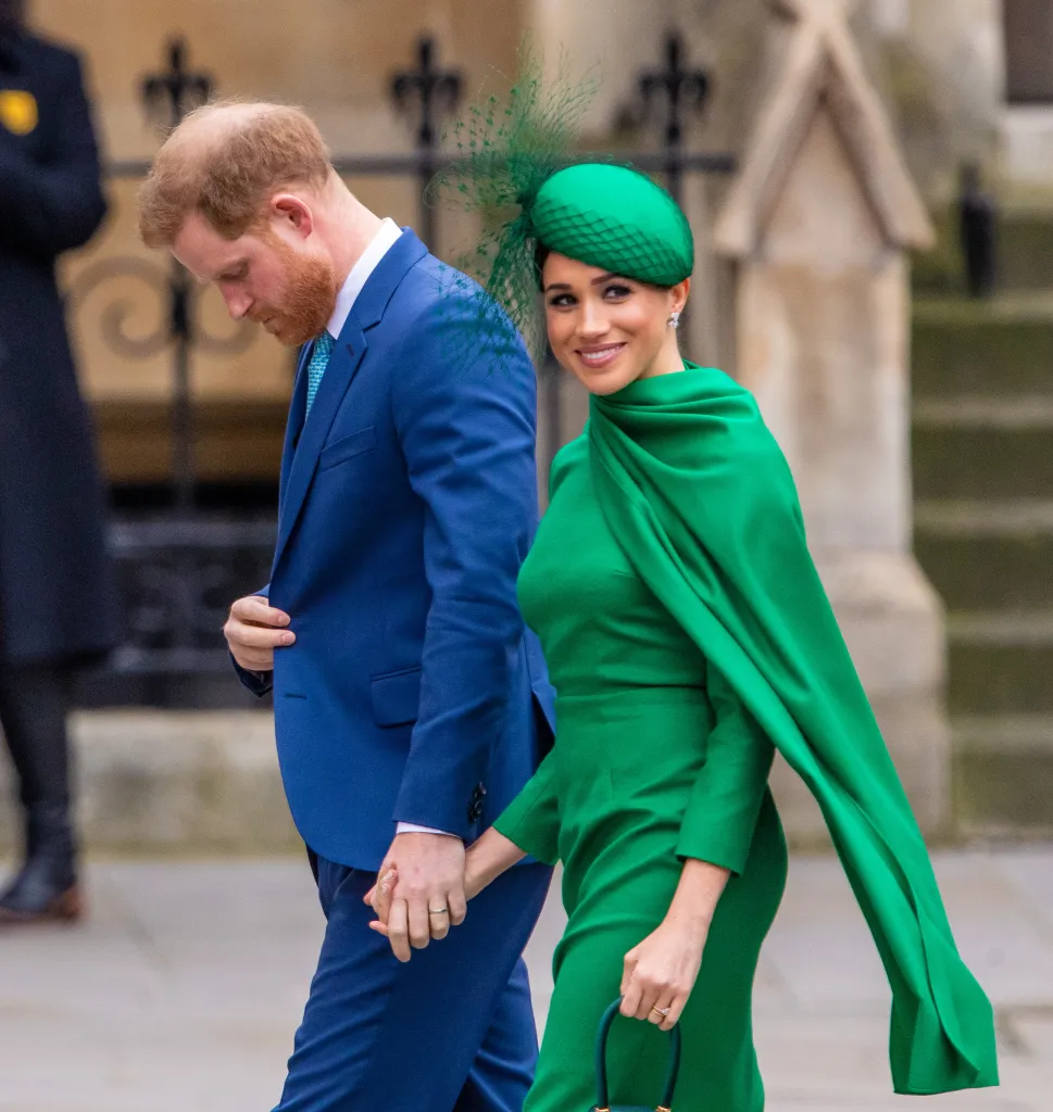 Prince Harry and Meghan Markle holding hands as they walk.