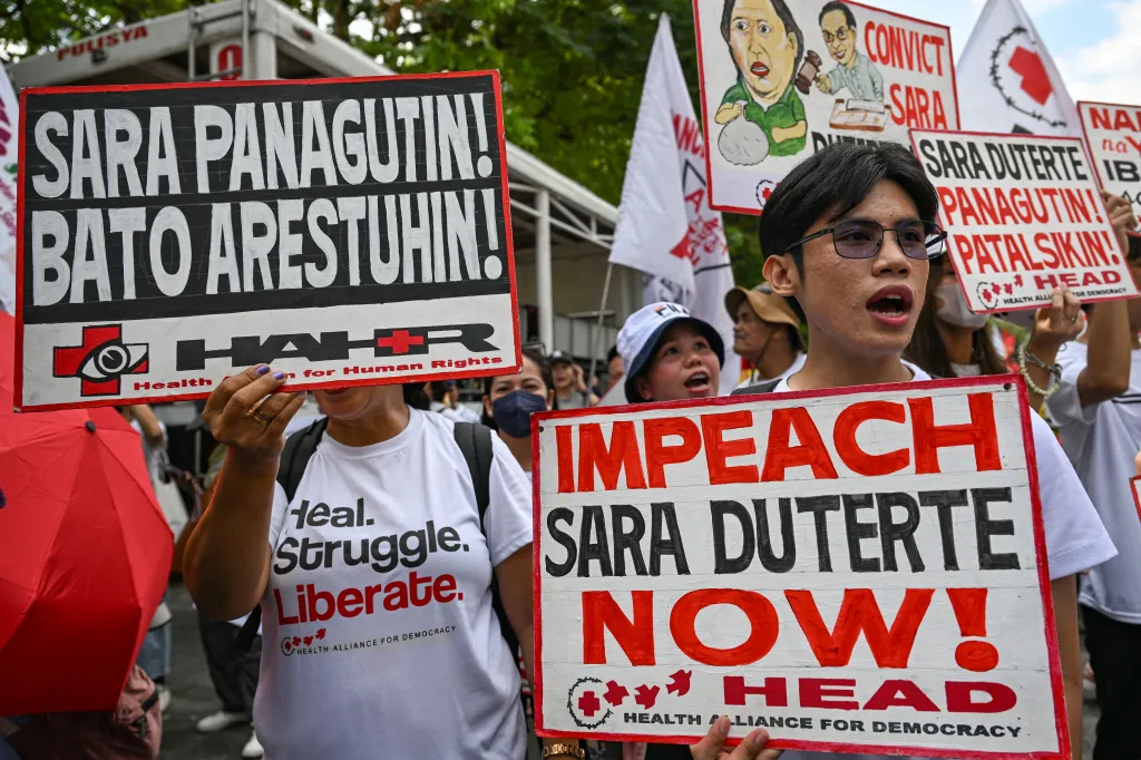 Protesters hold signs demanding accountability for Sara Duterte and Ronald 