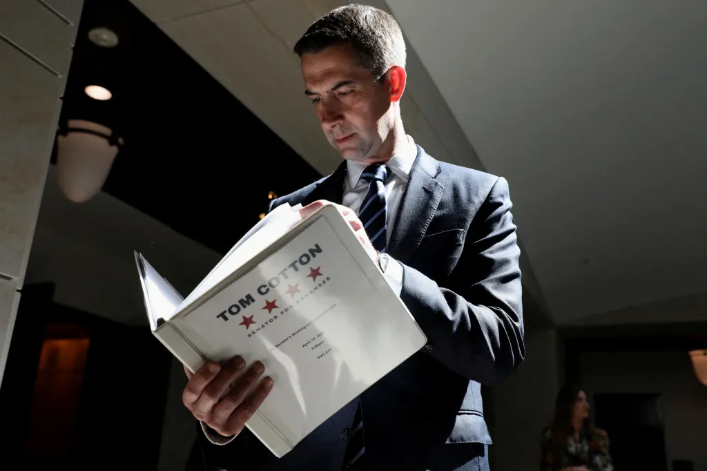 U.S. Senator Tom Cotton reading a document titled 