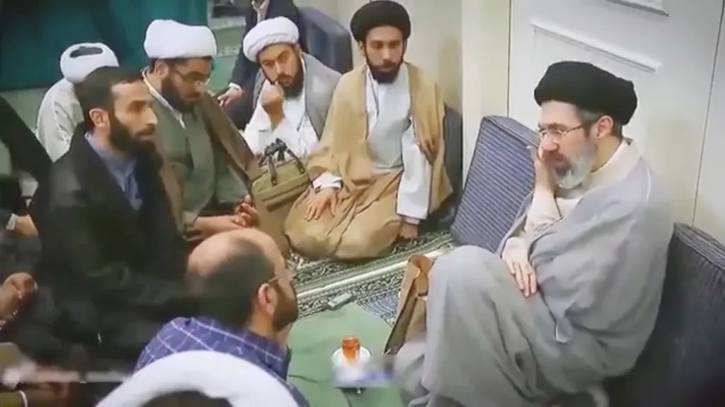 Seyyed Mojtaba Khamenei, Iran's Supreme Leader, giving a lesson session while sitting on a couch among other men in traditional dress.