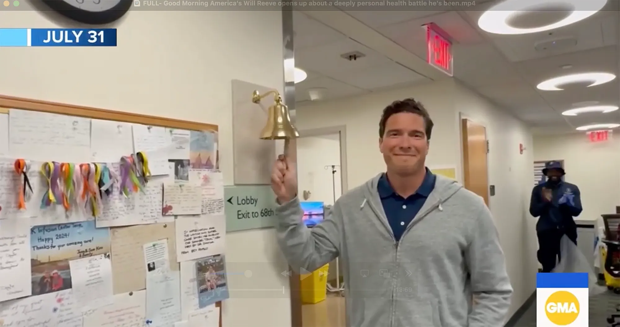 Will Reeve rings a victory bell in a hospital hallway.