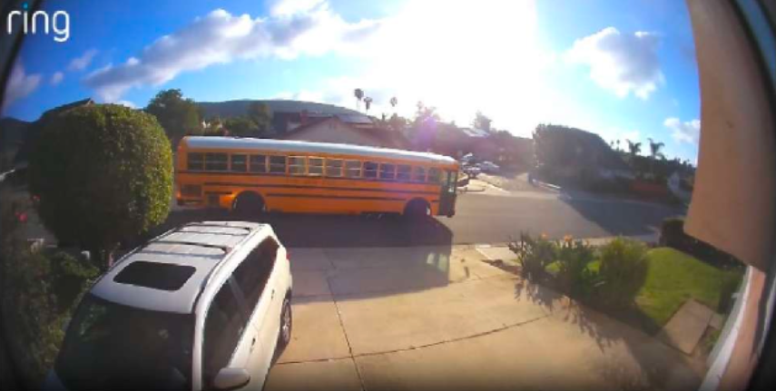Ring camera footage showing a yellow school bus on a residential street.