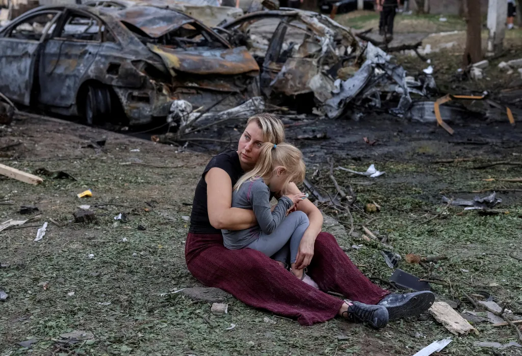A Ukrainian resident her daughter sit at the site of an apartment building damaged by a Russian missile strike in Borispil, Ukraine, on Sept. 1, 2026.