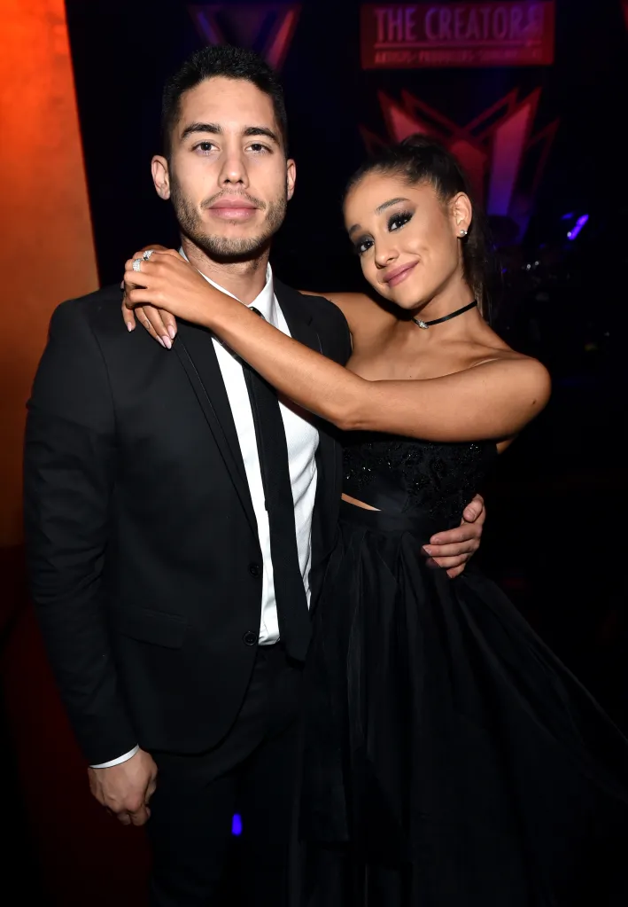 Ricky Alvarez and Ariana Grande posing for a picture at a party.