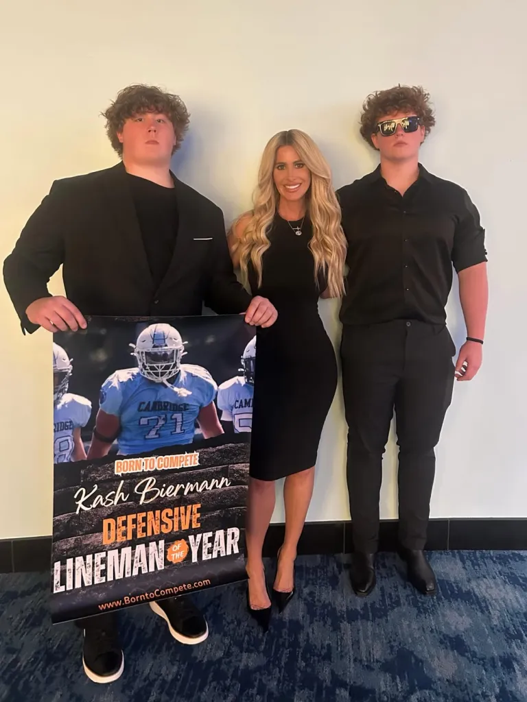 Kim Zolciak-Biermann poses with her sons, Kash Biermann, holding a 