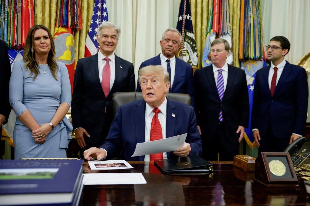 President Donald J. Trump making a healthcare announcement in the Oval Office, flanked by Sarah Huckabee Sanders, Robert F. Kennedy Jr., and Dr. Mehmet Oz.