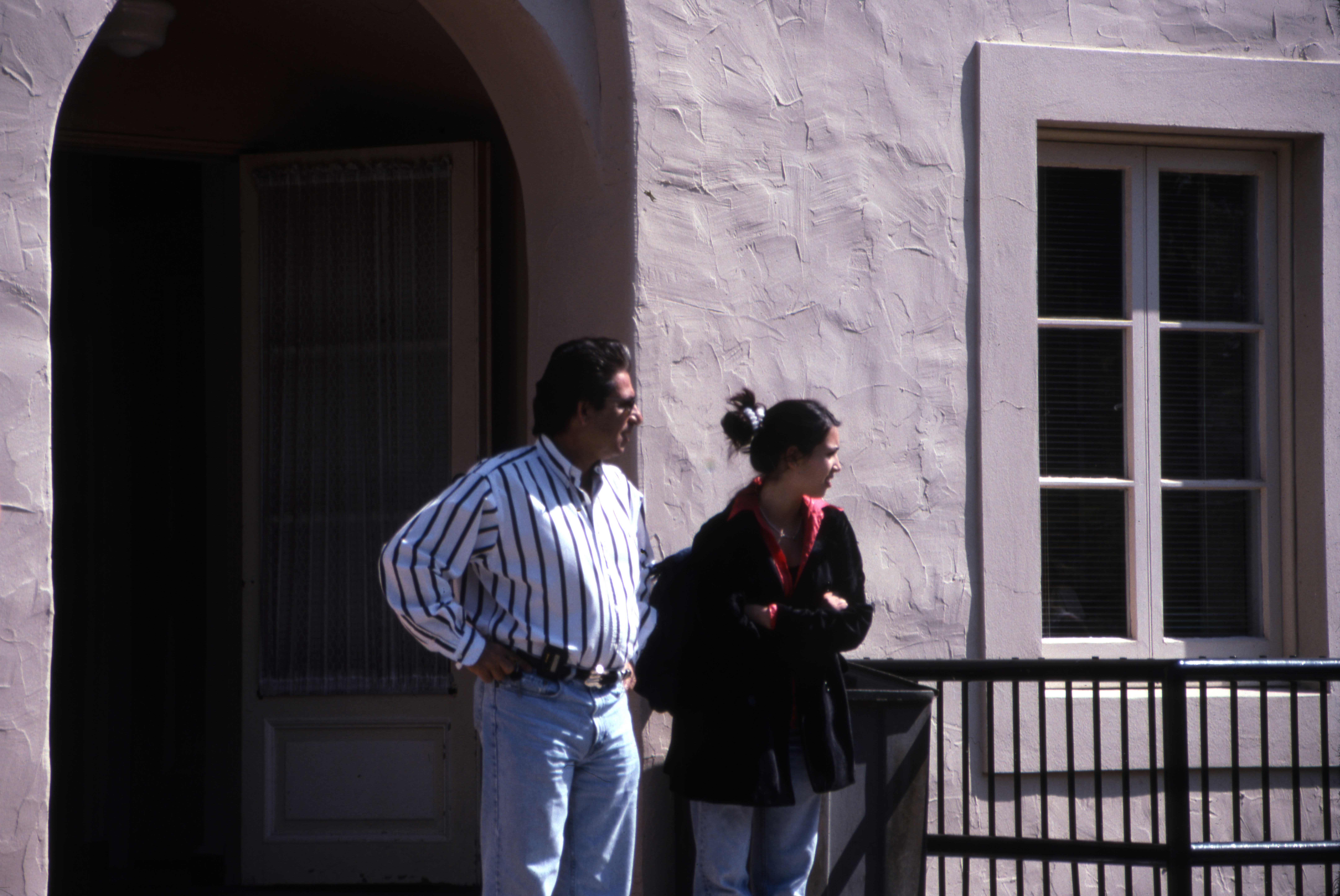 Robert Kardashian and Kim Kardashian stand outside her high school.