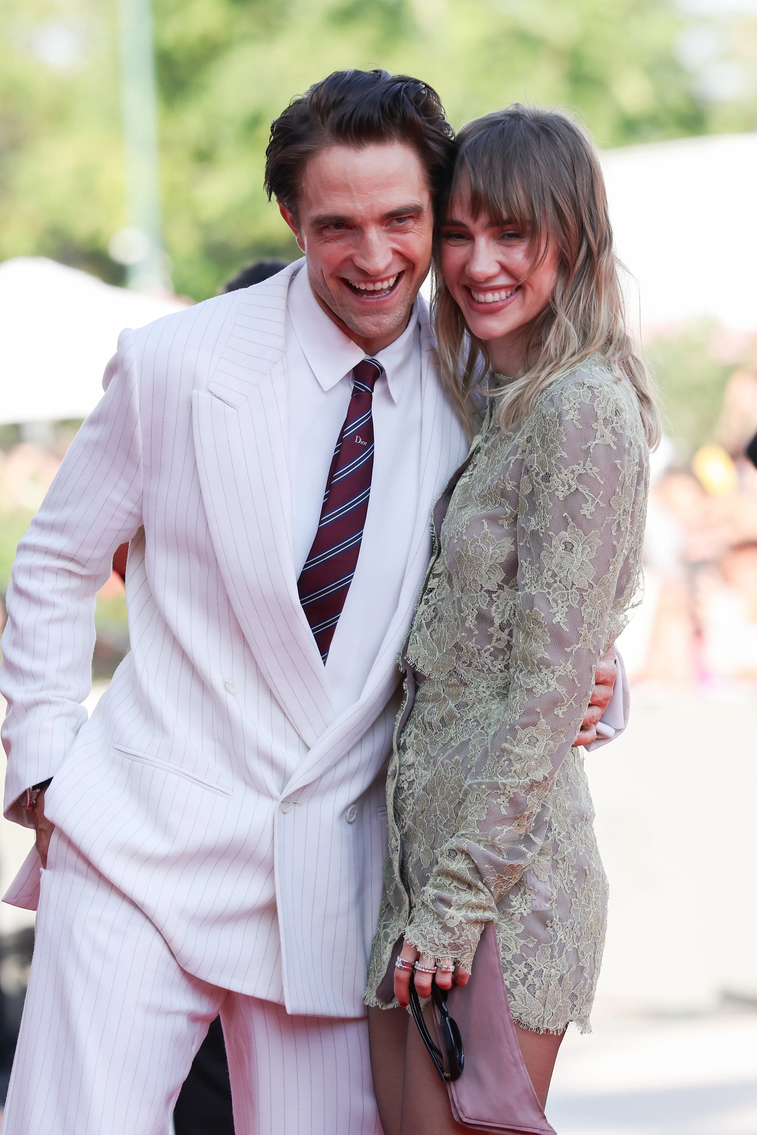 Robert Pattinson and Suki Waterhouse smiling at the 