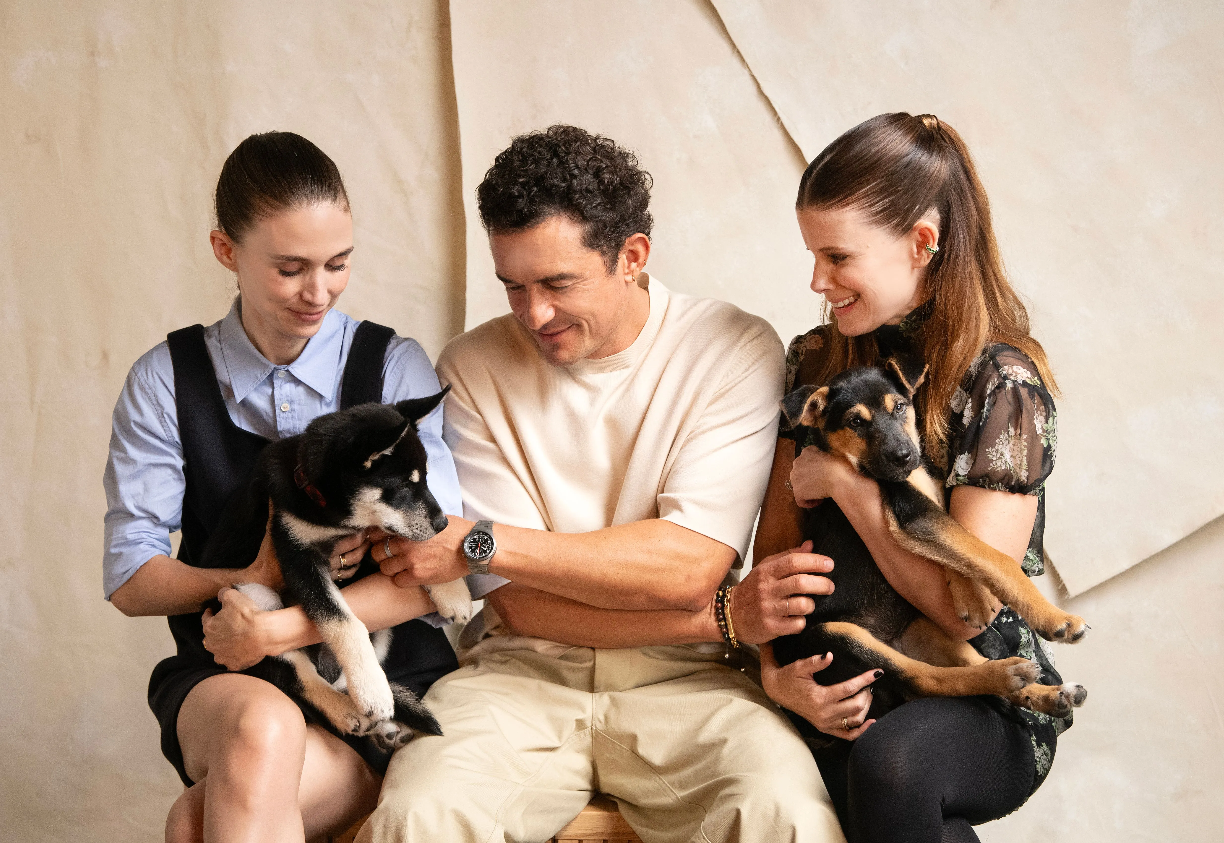Rooney Mara, Orlando Bloom, and Kate Mara holding puppies at the TIFF Portrait Studio.