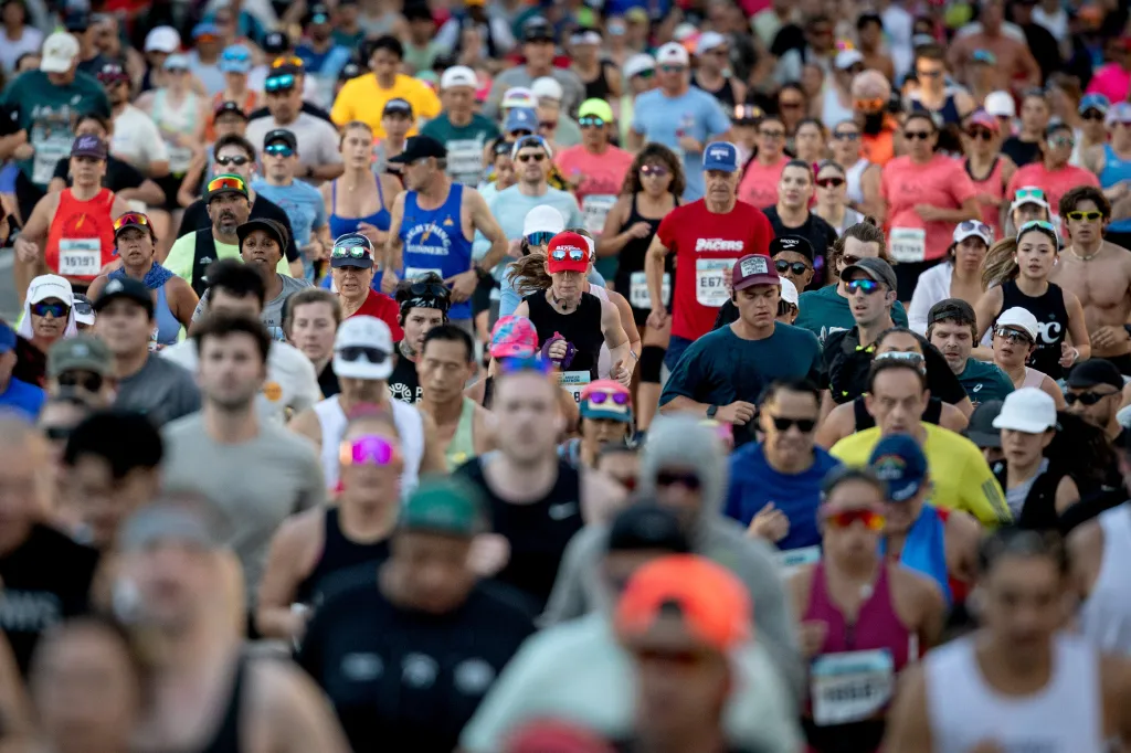 A crowd of diverse runners participates in the Los Angeles Marathon.