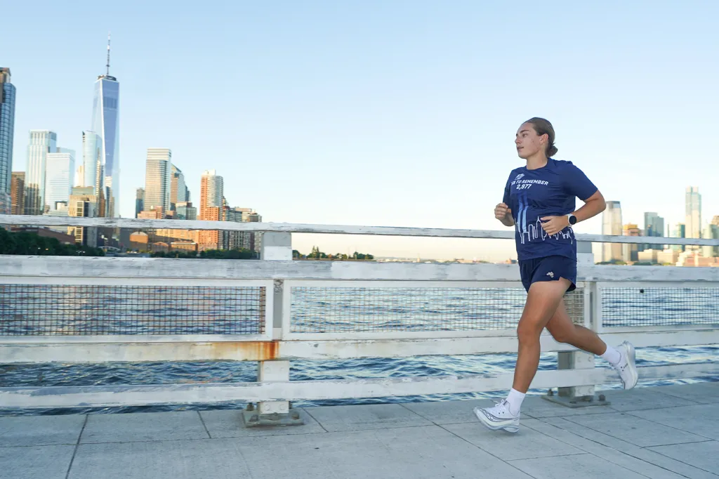 Hanna Born, 27, runs along Pier 34 on the West Side Highway in Manhattan on Tuesday, Sept. 8, 2026. Born, an Air Force captain, was 2 years old in the Pentagon's daycare center during the 9/11 attacks and is running 2,977 miles in honor of those who died that day.