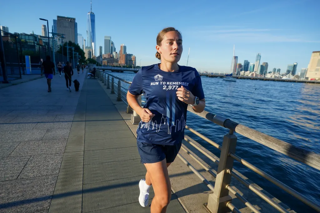 Hanna Born, 27, runs along the West Side Highway in Manhattan on Tuesday, Sept. 8, 2026. Born, an Air Force captain, was 2 years old in the Pentagon's daycare center during the 9/11 attacks and is running 2,977 miles in honor of those who died that day.