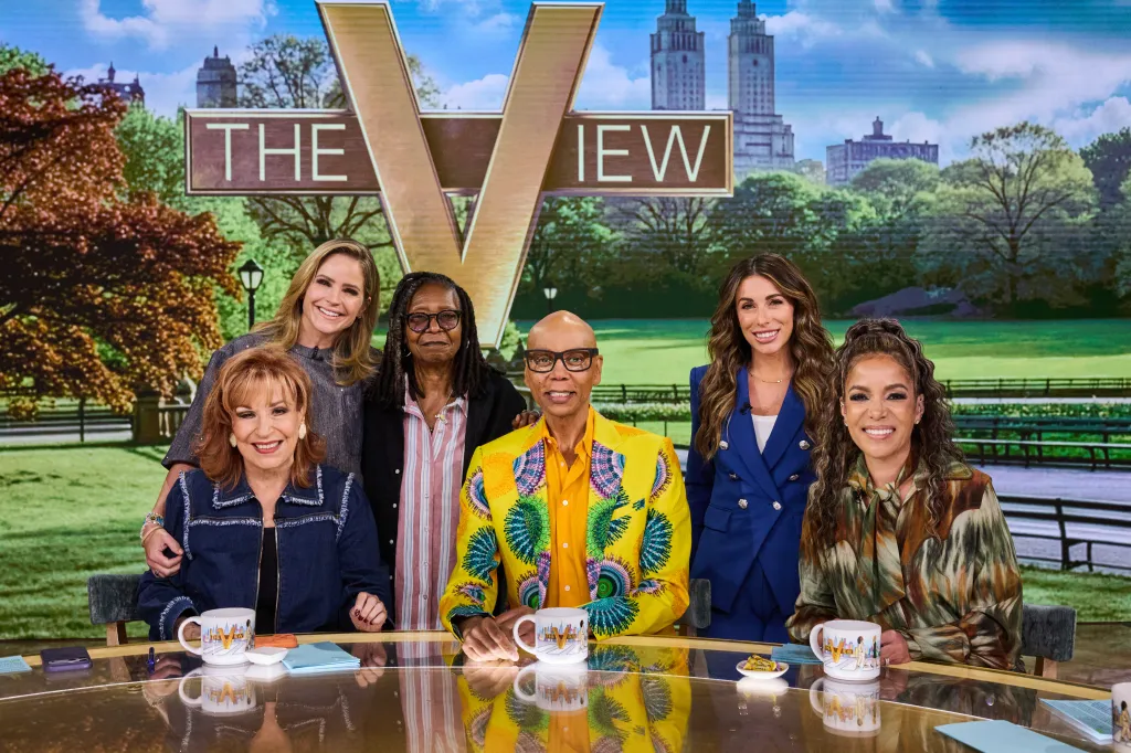 Joy Behar, Sara Haines, Whoopi Goldberg, RuPaul, Alyssa Farah, and Sunny Hostin sitting at 