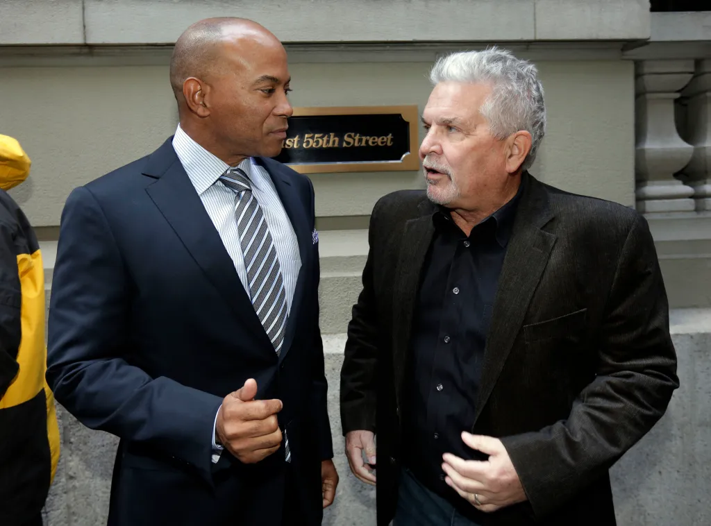 Sacramento city councilman Allen Warren and Sacramento Kings investor Phil Oates confer outside a hotel.