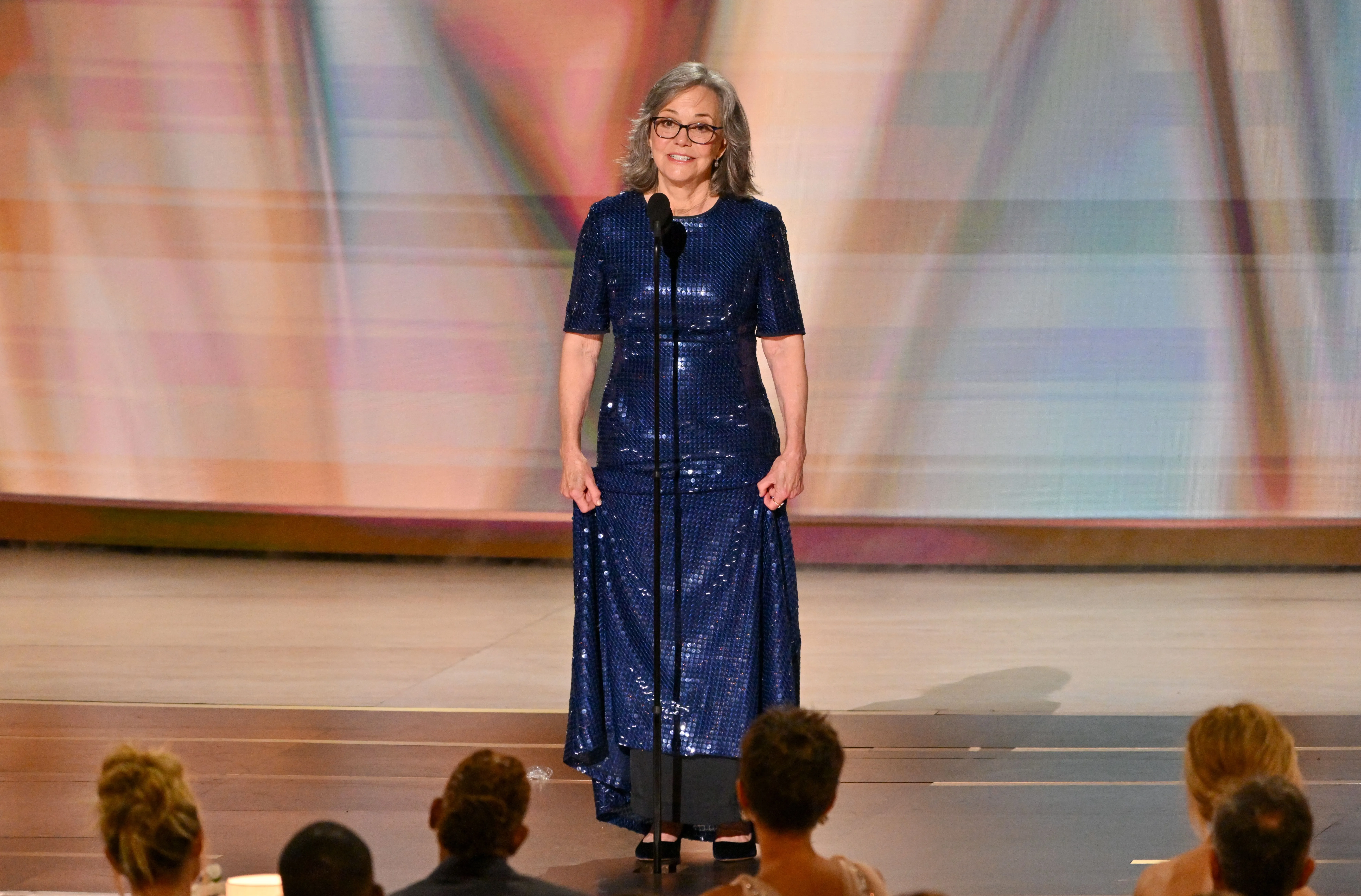 Sally Field speaking at the 78th Primetime Emmy Awards, wearing a blue sequined dress.