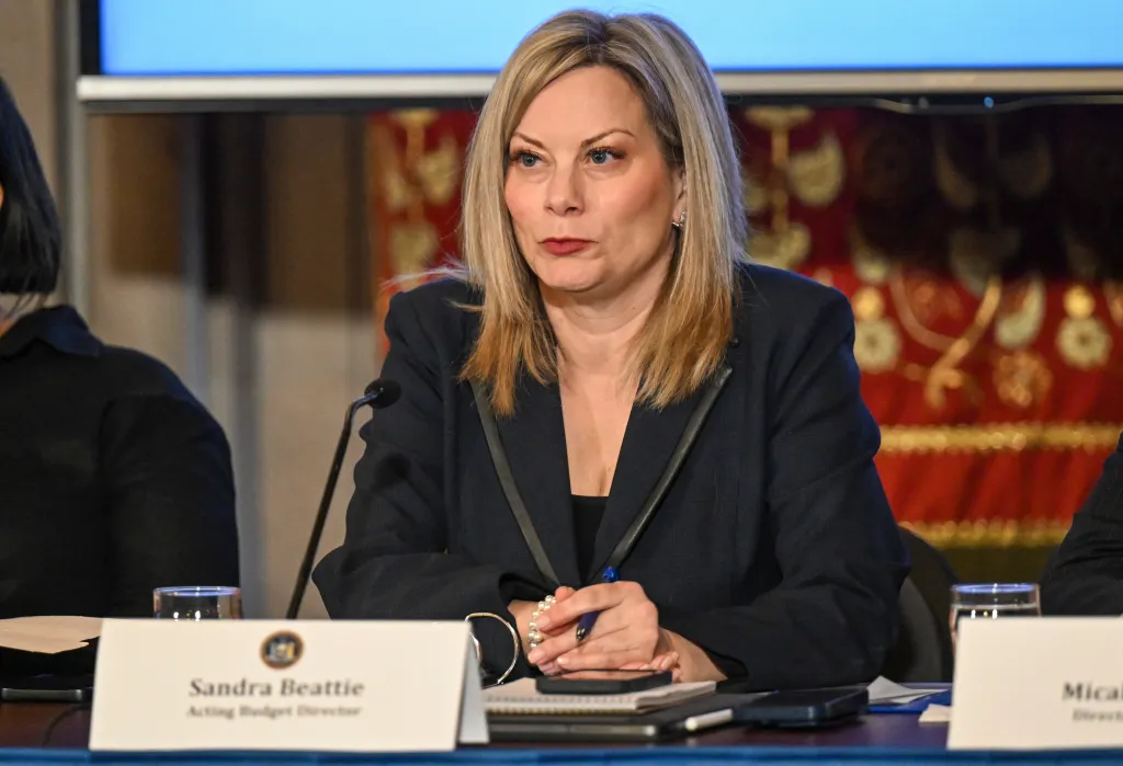 Sandra Beattie, acting budget director for New York State, listening during a budget presentation.