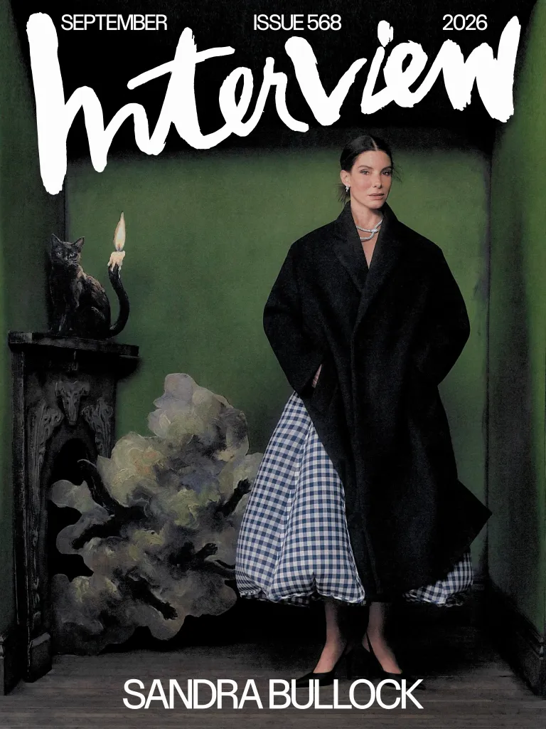 Sandra Bullock on the September 2026 cover of Interview magazine, wearing a black coat and checkered skirt.