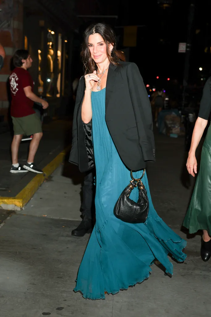 Sandra Bullock in a teal dress and black blazer in SoHo.