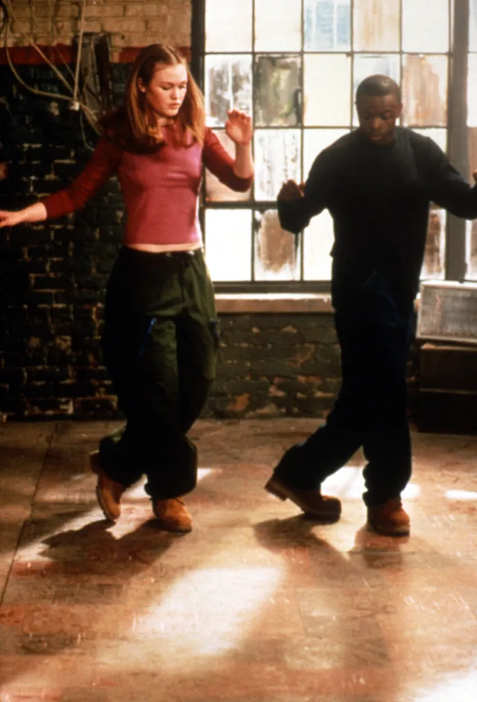 Julia Stiles and Sean Patrick Thomas dancing together in a movie still from 
