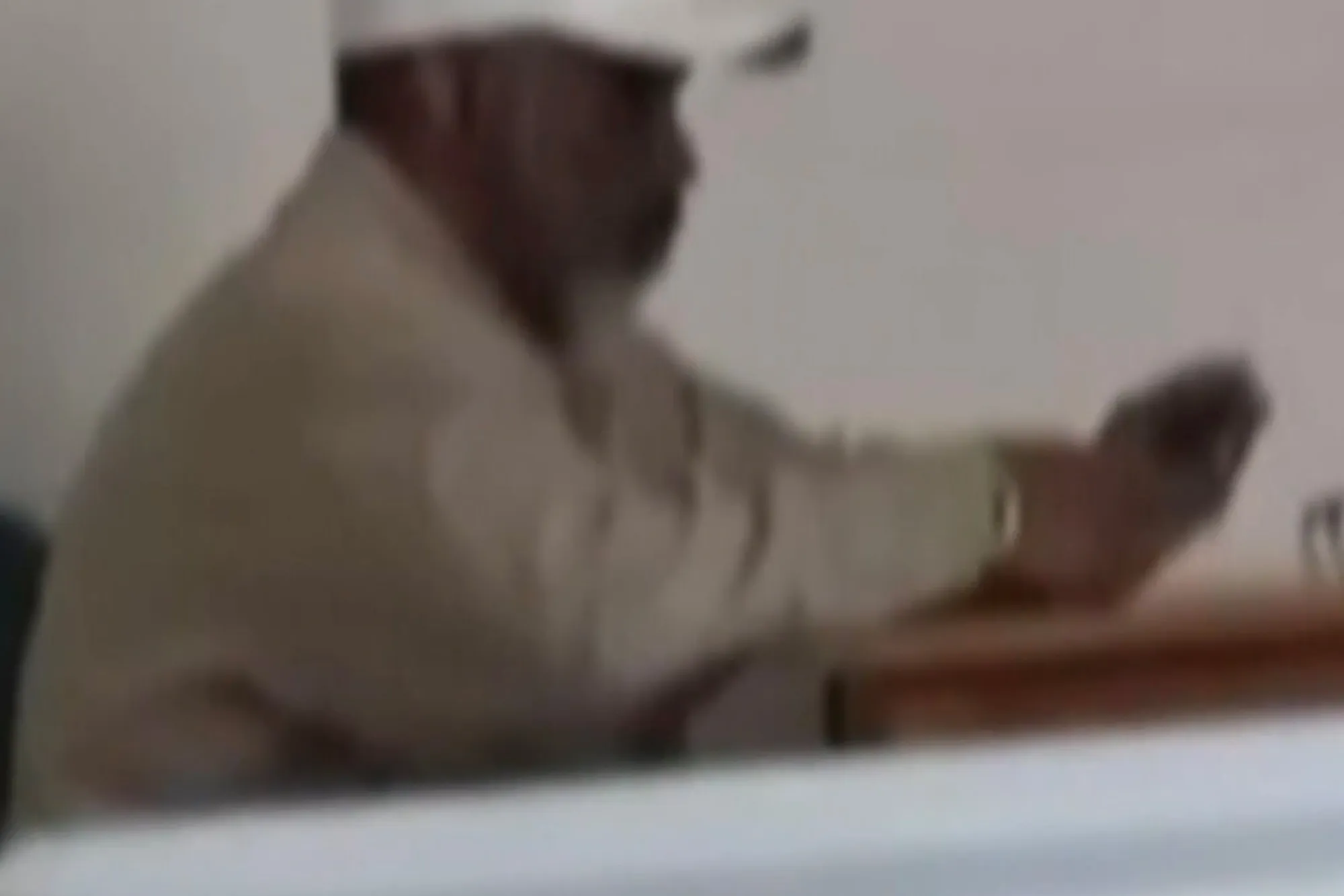 Sean Combs sitting at a table in prison.
