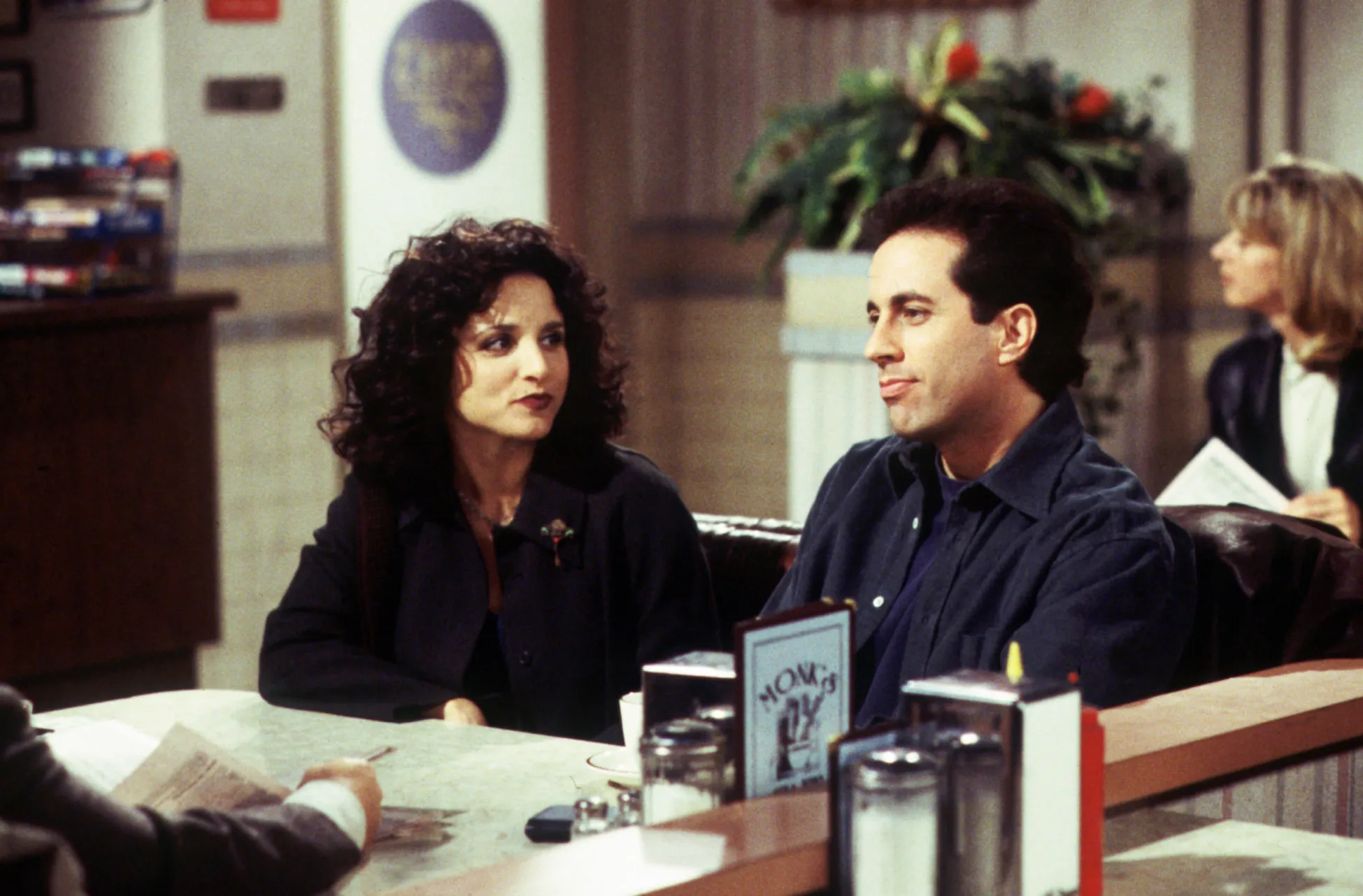 Julia Louis-Dreyfus and Jerry Seinfeld at a diner in Season 9 of Seinfeld.