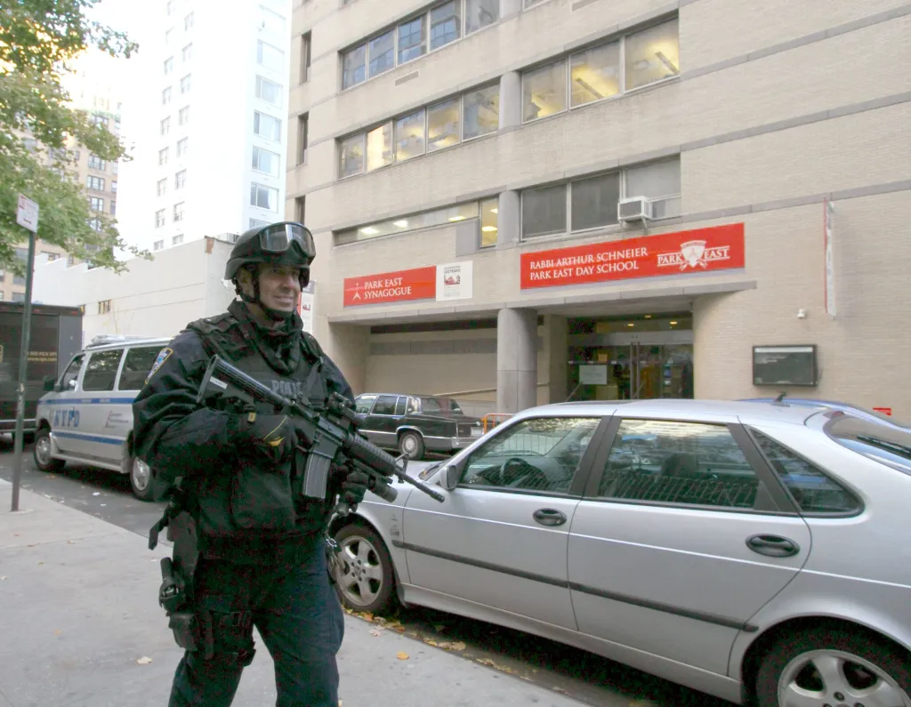 Security officer with a rifle in front of the Park East Synagogue on E 68th St.