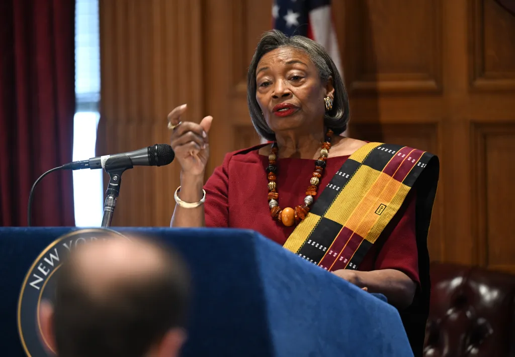 Senate Majority Leader Andrea Stewart-Cousins speaks at a podium with a microphone.