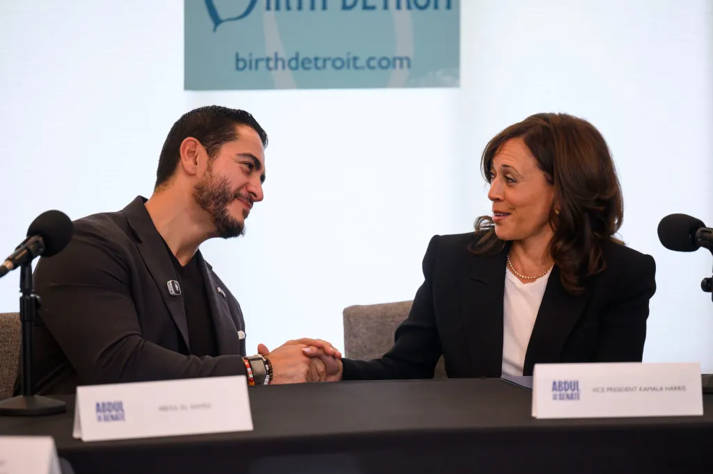 Senatorial candidate Dr. Abdul El-Sayed and Vice President Kamala Harris shaking hands during a roundtable discussion.