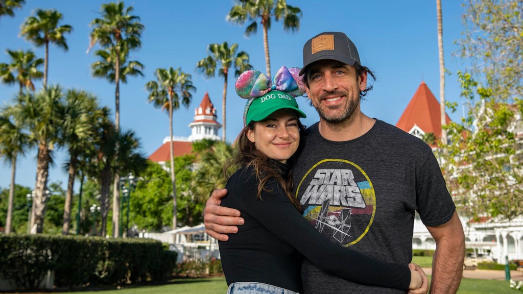 Shailene Woodley and Aaron Rodgers smiling while embracing outdoors.
