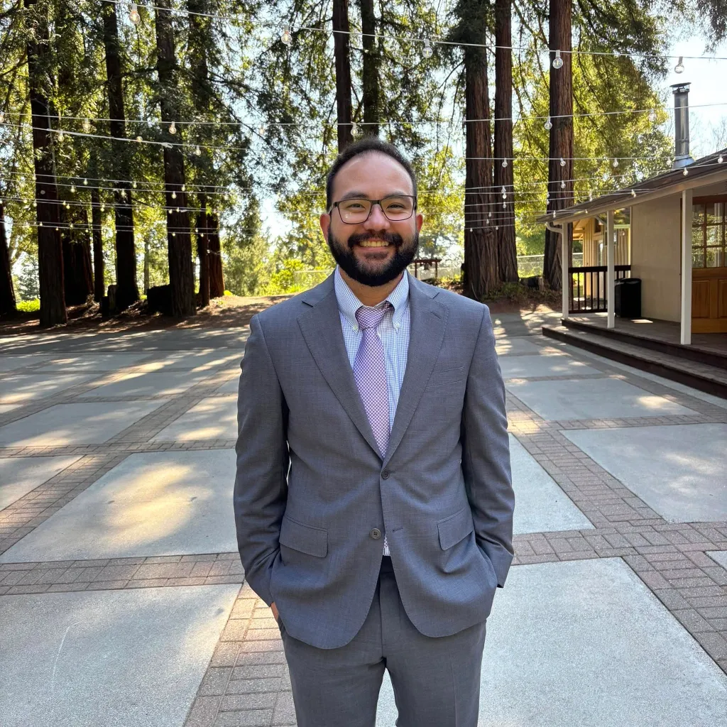 Jonathan McKinsey, a tech executive at The New York Times, smiling while wearing a gray suit and a purple tie.